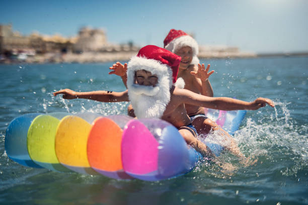 istock Two little boys on pool raft enjoying summer Christmas on the beach 1496152605