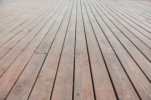 Perspective view wooden floor. Wooden pier close-up. Wooden slats used for the terrace floor.