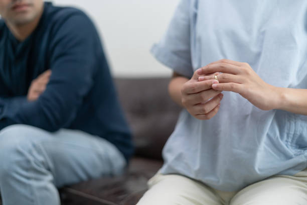 istock Quarrel, Divorce. husband and wife remove married ring. Couples desperate and disappoint after marriage. Divorce document, upset and frustrated after conflict. distrust, love problems, betrayals 1496155854