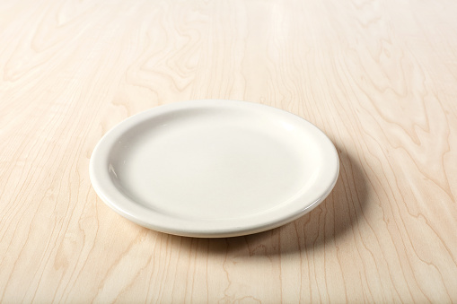 Close up single empty plate on tabletop