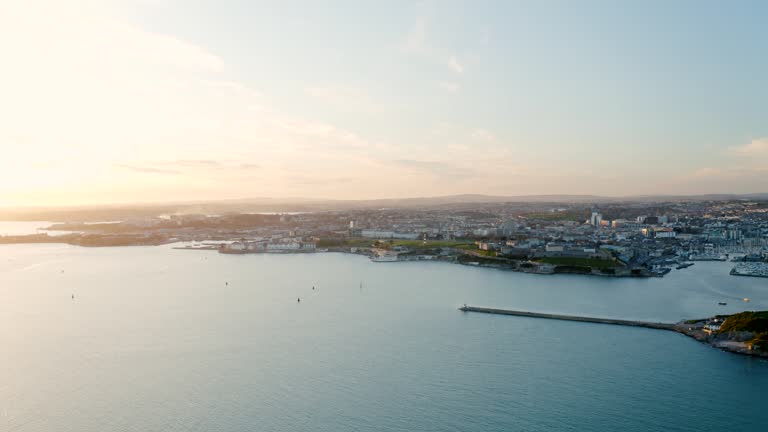 Drone sunset over ocean front city, Plymouth