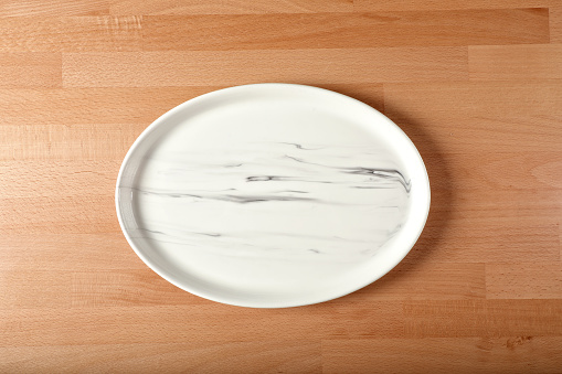 Close up single empty plate on tabletop