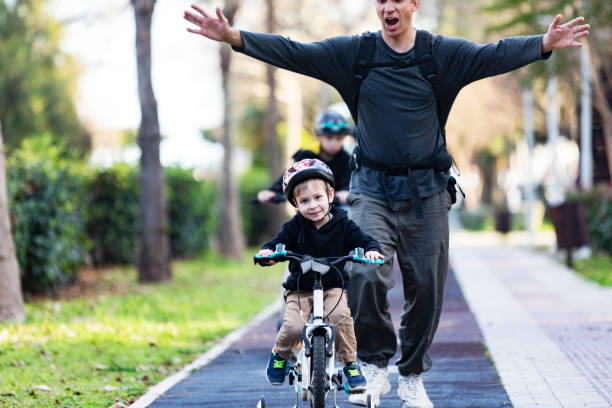 Father teaching his son to ride bicycle