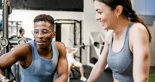 istock Fit trainer explaining exercise to woman in gym 1496161908