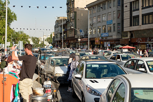 A street in uptown Tehran with heavy traffic on a sunny day. Iranians spend a lot of time commuting.