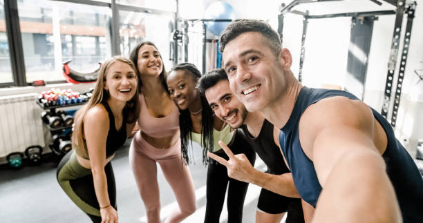 istock Cheerful diverse sportspeople doing selfie at gym 1496162073