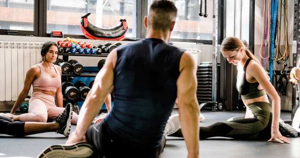 istock Young friends practicing fitness exercise together on floor 1496162687