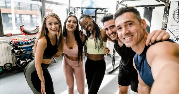 istock Cheerful diverse sportspeople doing selfie at gym 1496162829