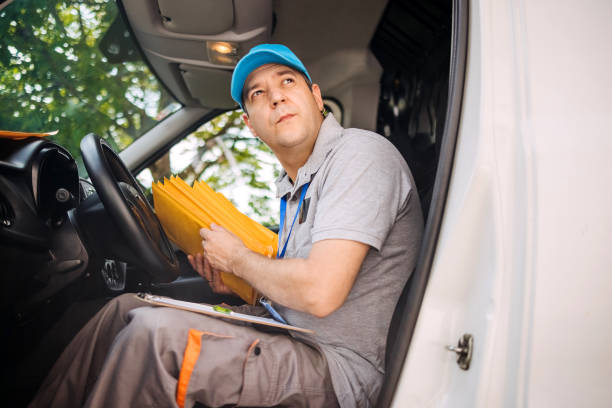 Delivery person looking for envelope before delivery to customer