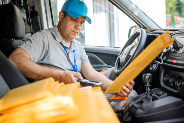 Delivery person scanning envelope before delivery to customer
