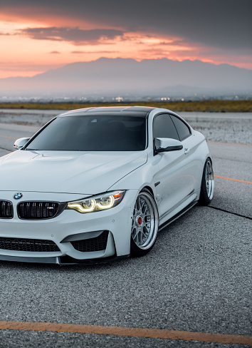 LA, CA, USA
June 4, 2023
BMW M4 in white parked showing the front of the car with sun going down