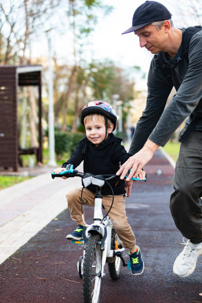 istock Father teaching his son to ride bicycle 1496166220