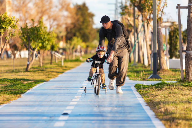 Father teaching his son to ride bicycle