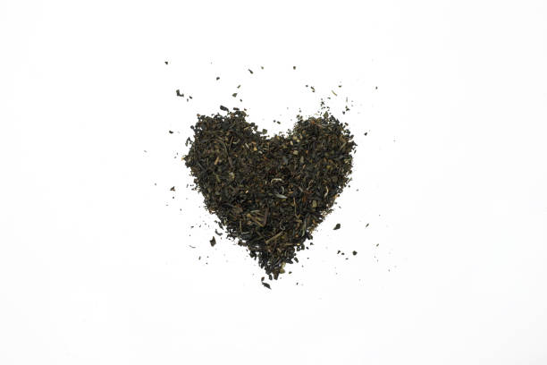 istock Dried tea arranged in a heart shape close-up with white background. 1496167883