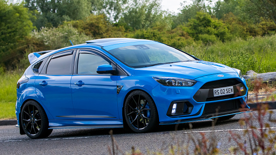 Stony Stratford,UK - June 4th 2023: 2016 blue  FORD FOCUS RS  classic car travelling on an English country road.