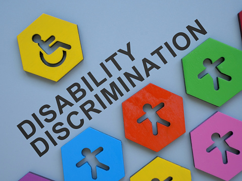 Small colorful figurines and words disability discrimination.