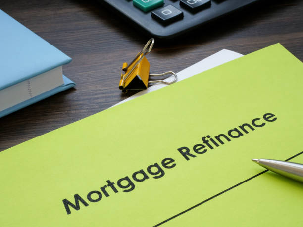 istock Papers with information about mortgage refinance on the table. 1496171804