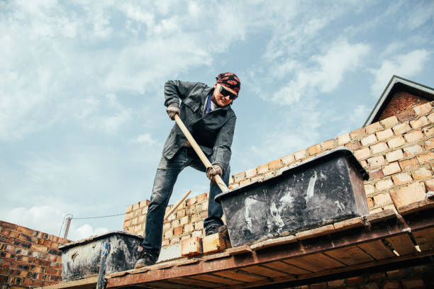 istock An experienced worker works on the construction of a brick house 1496173542