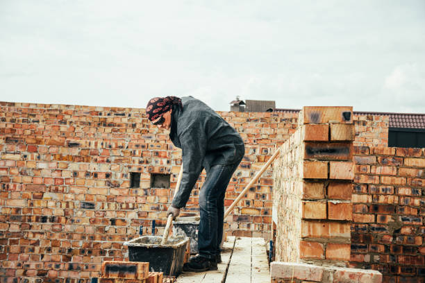istock An experienced worker works on the construction of a brick house 1496173586