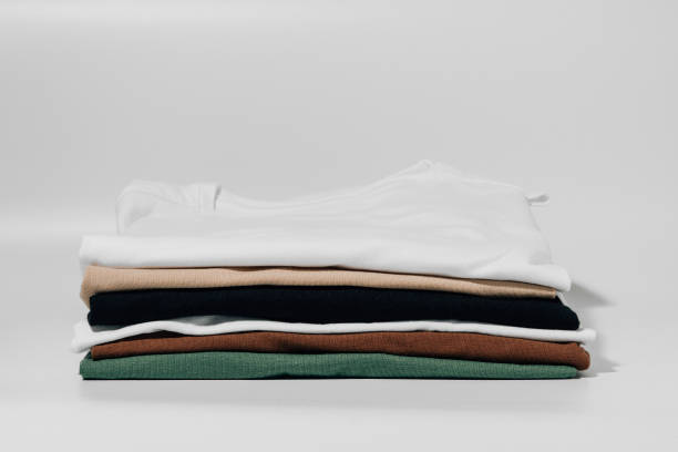 istock T-shirts folded in a neat stack on a white isolated background. The concept of changing the wardrobe, tidying up the house and new clothes 1496175112