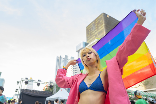 Happy Asian friend having fun in the street LGBTQ pride parade. in bangkok