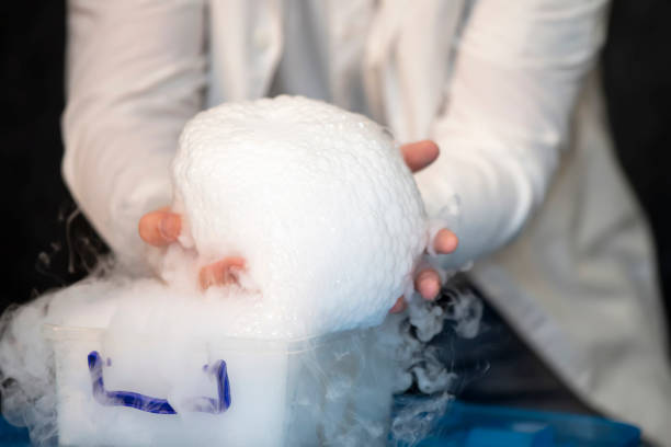 istock Laboratory chemistry experiment with foam and steaming.Laboratory chemical experiment with foam and steam. Hands holding foam. 1496178024