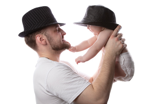 Funny father and kid in classic hats. Father and little son.