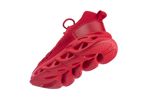Flying red rag sneaker with a corrugated sole on a white background. Sport shoes.