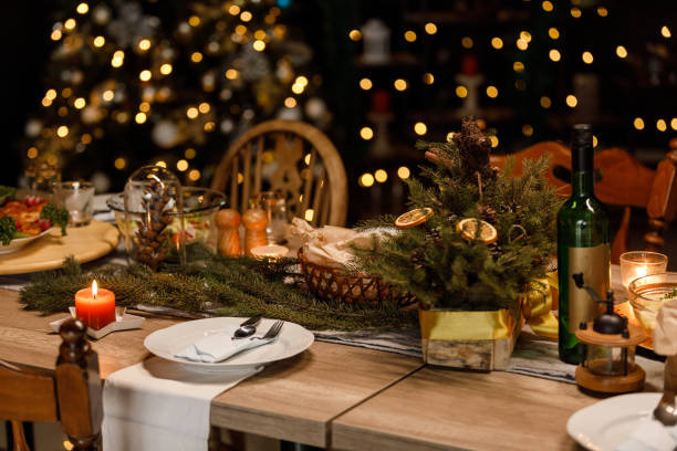 istock Christmas lights glistening in the background behind a rustic dining table set for a Christmas dinner party 1496178509
