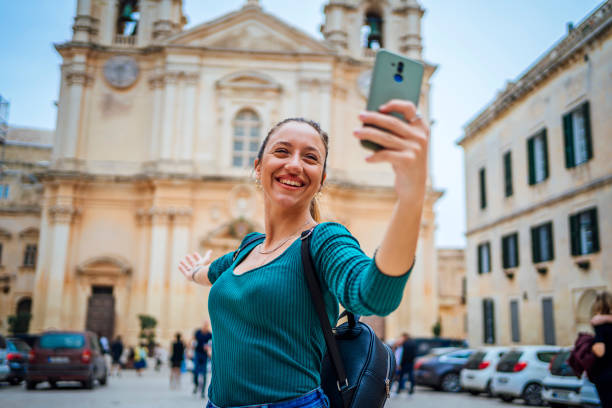 istock Young woman having a video call in Mdina, Malta 1496179482