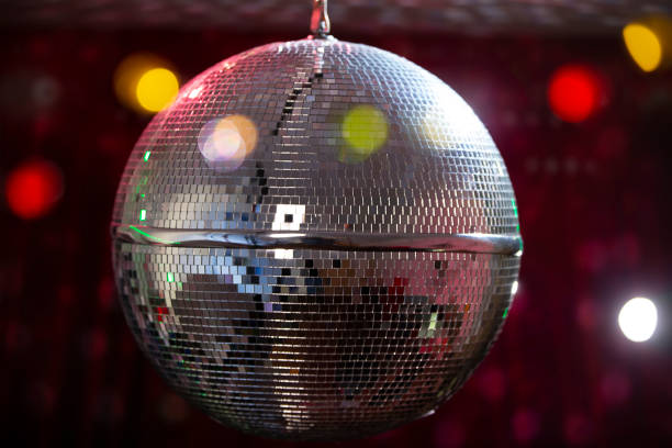 istock Disco ball with bright beams, night party background photo. 1496180875