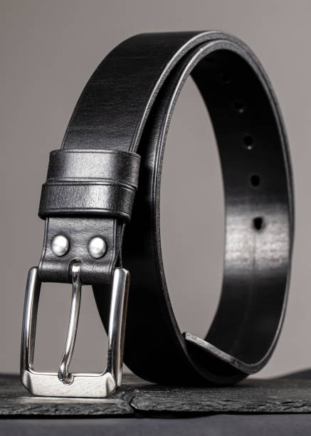 istock Leather belt twisted into a circle on a gray background. 1496180951