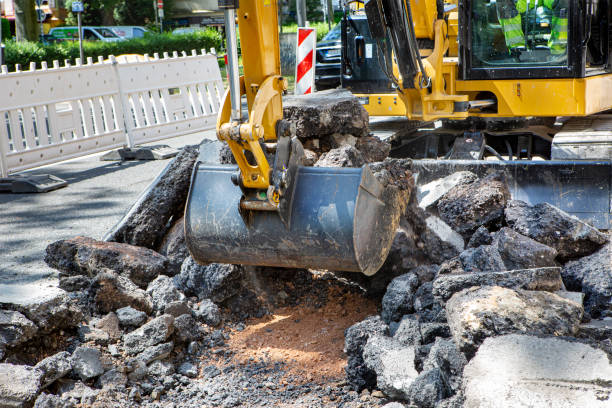istock Road works - excavator tears up the road 1496181637