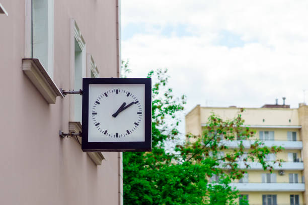 istock A square clock with hands on the building shows ten minutes past two 1496181683