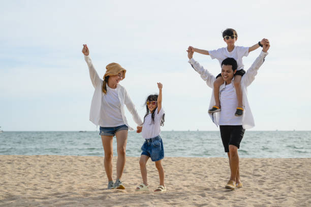 istock Happy family spending vacation time together on beach 1496181701