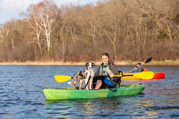 istock Girl & Dog Kayaking on Lake in Springtime 1496186236