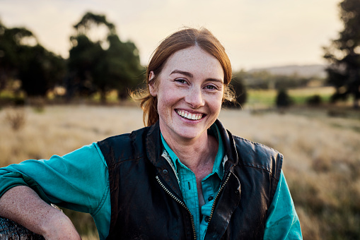 Portrait of a young female farmer on her farm in rural Tasmania, Australia.