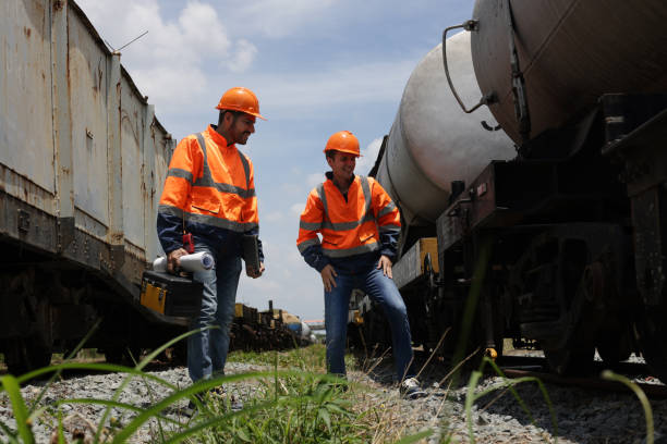 istock Architecture, construction building with an architect,  railway engineer and designer working as a team and plan to works ,Working at  oil tank at railway station 1496188398
