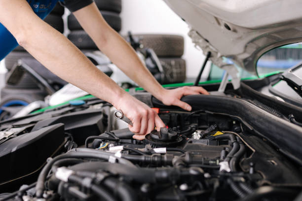 istock Auto mechanic working in garage. Human hands hold tools. Repair service concept 1496188999