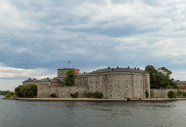 istock View of building by sea against cloudy sky 1496189819