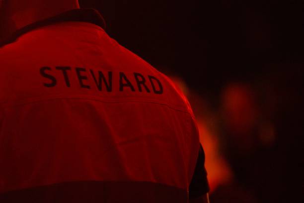 istock Steward, bouncer on phone from behind 1496191109