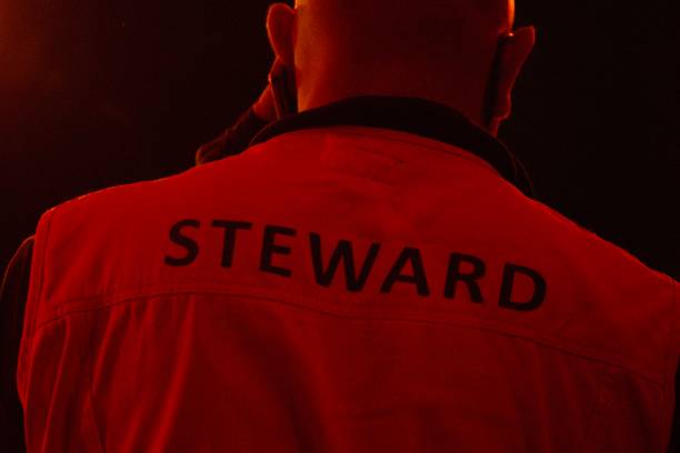 istock Steward, bouncer on phone from behind 1496191153