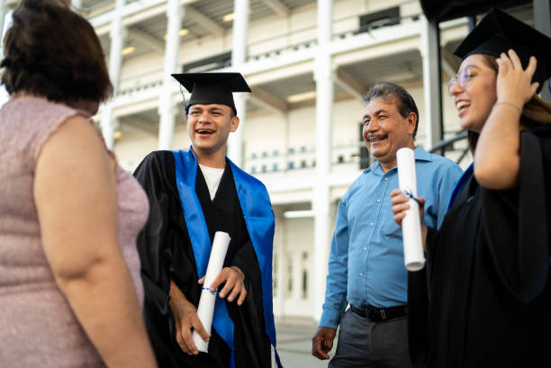 istock Young graduates talking with their parents on graduation 1496191788