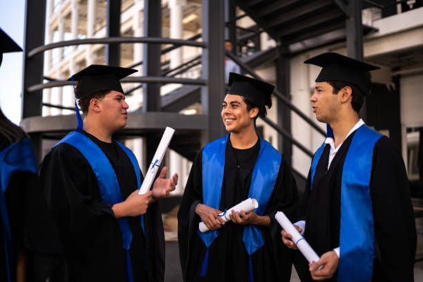 istock Young graduates men talking on their graduation 1496191820