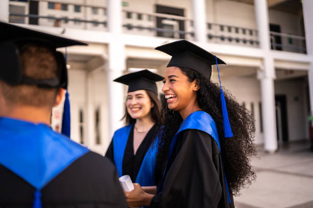 Young graduate woman talking with her friends on graduation