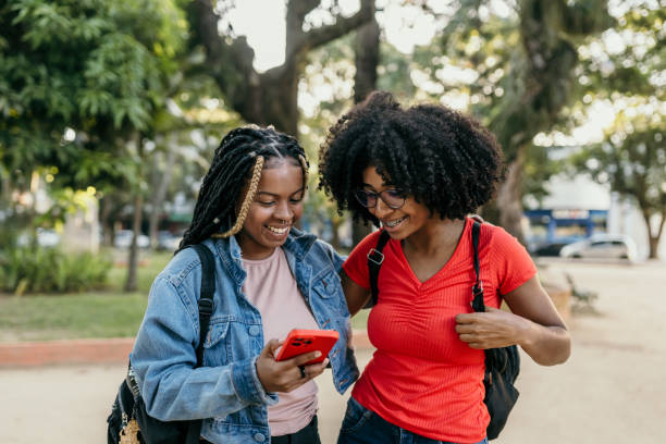 istock Friends using smartphone in the city 1496191909