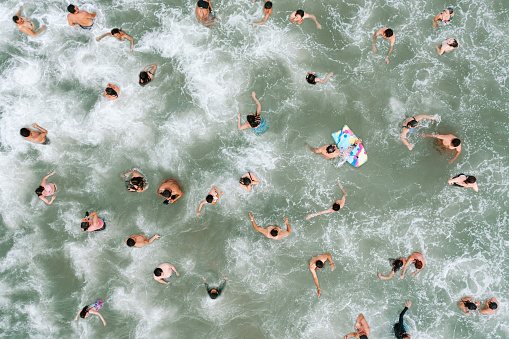 Aerial view of a crowd swimming at Acapulco beach.  Photo taken with a drone in the summer of 2022