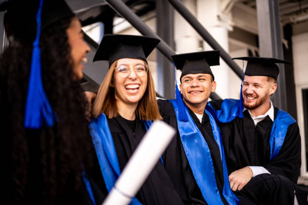 istock Young graduates friends talking on graduation 1496192006
