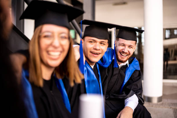 istock Young graduates friends talking on graduation 1496192018