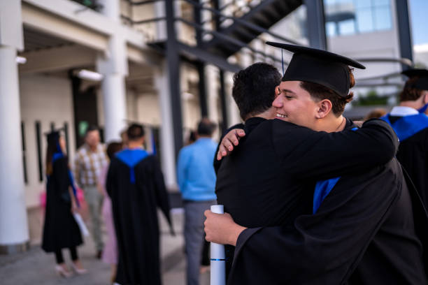 istock Young graduate man embracing his father on the graduation 1496192390